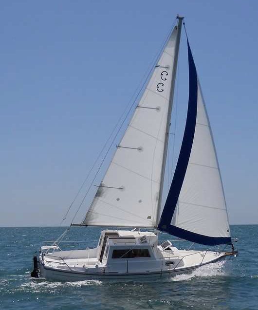 Com pac 23 pilothouse sailboat under sail