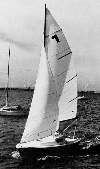 Red jacket 17 sailboat under sail