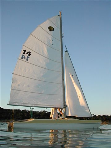Tiger cat sailboat under sail